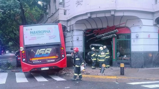 Vehículos de emergencia trabajan en el lugar del accidente en avenida San Juan, donde un patrullero impactó contra una pizzería.